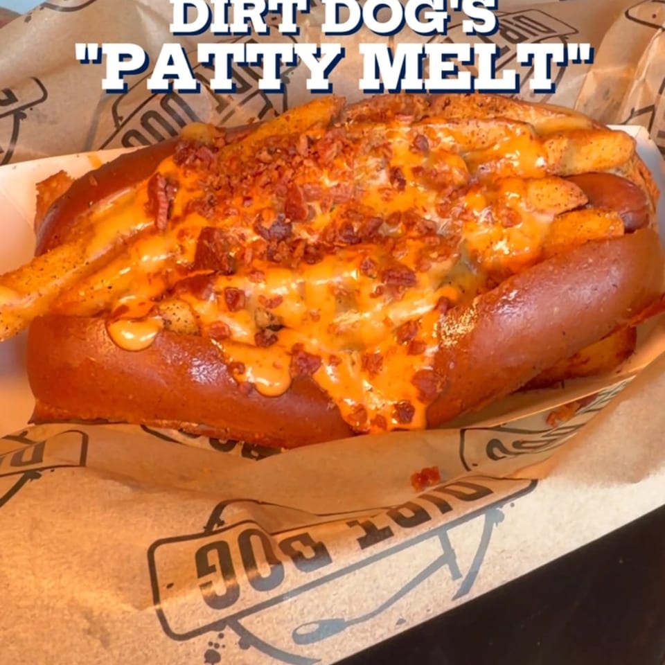 Dirt Dog's "Patty Melt" hot dog, loaded with cheese sauce, fries, and bacon bits.